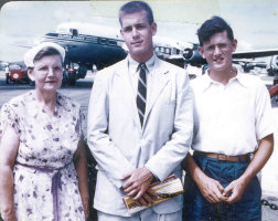 Mary MacLean Macky, David Wallace Macky, and Ian Wallace Macky at airport, PAA Clipper Andrew Jackson in background